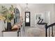 Charming entryway featuring a decoratively appointed console table with a view to the exercise room at 4108 Mellon Dr, Odessa, FL 33556