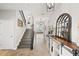 Bright foyer boasts wood-look tile flooring, a staircase with an iron banister, and decorative accents at 4108 Mellon Dr, Odessa, FL 33556
