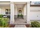 Covered front porch with stone accents, a welcoming entrance, and cozy seating area at 4108 Mellon Dr, Odessa, FL 33556