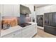 Modern kitchen features white cabinets, stainless steel appliances, quartz countertops, and tile backsplash at 4108 Mellon Dr, Odessa, FL 33556