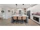 Modern kitchen features a spacious island with seating, pendant lighting, and sleek white cabinetry at 4108 Mellon Dr, Odessa, FL 33556