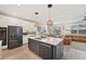 Modern kitchen featuring white cabinets, quartz countertops, stainless steel appliances, and a stylish island at 4108 Mellon Dr, Odessa, FL 33556