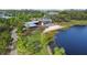 Aerial view of a lakeside retreat with a modern building and access to the water at 4108 Mellon Dr, Odessa, FL 33556