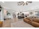 Bright open-concept living area with kitchen, dining space, and cozy leather seating, enhanced by natural light at 4108 Mellon Dr, Odessa, FL 33556