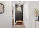 Hallway view of a mudroom equipped with coat hooks, a bench, and convenient storage options at 4108 Mellon Dr, Odessa, FL 33556