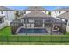 Aerial view of a private screened-in pool, lounge seating, and backyard living area at 4108 Mellon Dr, Odessa, FL 33556