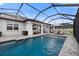 Beautiful screened-in pool with outdoor furniture and stylish patio at 4108 Mellon Dr, Odessa, FL 33556