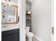 Chic powder room with patterned wall and sleek fixtures at 4108 Mellon Dr, Odessa, FL 33556