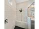 Modern shower with a bench seat, dual shower heads, and light tile at 4108 Mellon Dr, Odessa, FL 33556