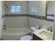 Renovated bathroom with white tile and a tub and shower combination at 4301 15Th N Ave, St Petersburg, FL 33713