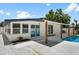 Backyard featuring a pool, white privacy fence, covered patio, and desert landscaping at 4675 26Th N Ave, St Petersburg, FL 33713