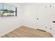 Bright bedroom featuring hardwood floors and a window letting in natural light, and a door at 4675 26Th N Ave, St Petersburg, FL 33713