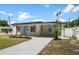 Inviting white home with a cozy covered carport and stylish landscaping creating great curb appeal at 4675 26Th N Ave, St Petersburg, FL 33713