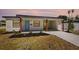 Quaint white single-story residence boasting a covered carport and well-manicured front yard at 4675 26Th N Ave, St Petersburg, FL 33713