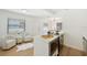 Bright open concept kitchen with stainless steel appliances, island, and open views to dining area and sitting room at 4675 26Th N Ave, St Petersburg, FL 33713