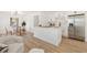 Open concept kitchen features white cabinets, stainless steel appliances, and bright dining area at 4675 26Th N Ave, St Petersburg, FL 33713