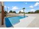 Inviting backyard pool with a spacious concrete deck and secure white fence under a bright blue sky at 4675 26Th N Ave, St Petersburg, FL 33713