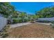 Backyard view showing a spacious yard with a pool and slide, surrounded by a white fence at 4806 W Melrose Ave, Tampa, FL 33629