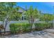 A glimpse of the home's backyard highlighting the white fence and the lush greenery, creating a private outdoor space at 4806 W Melrose Ave, Tampa, FL 33629