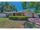 Charming single-story brick home featuring a well-maintained front yard and a two-car garage at 4806 W Melrose Ave, Tampa, FL 33629