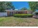 A single-story brick home with manicured landscaping and an attached garage at 4806 W Melrose Ave, Tampa, FL 33629