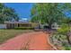 Charming single-story brick home with a red brick driveway and well-maintained landscaping at 4806 W Melrose Ave, Tampa, FL 33629