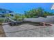 Backyard pool area showcasing a pool with a slide and a concrete deck, enclosed by a privacy fence at 4806 W Melrose Ave, Tampa, FL 33629