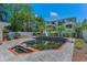 Inviting backyard pool featuring a slide and charming tile accents, set against a lush landscape at 4806 W Melrose Ave, Tampa, FL 33629