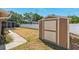 Spacious backyard featuring a large shed, white fence, and screened-in porch perfect for outdoor living at 506 Spring Tree Ct, Tarpon Springs, FL 34689