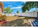 Enjoy a nice backyard with a white fence creating an ideal space for outdoor relaxation and recreation at 506 Spring Tree Ct, Tarpon Springs, FL 34689