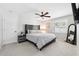 Serene bedroom with a comfortable bed, modern ceiling fan, and natural light from the window at 506 Spring Tree Ct, Tarpon Springs, FL 34689