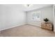 Cozy bedroom with neutral carpet, plantation shutters, and a decorative wooden chest at 506 Spring Tree Ct, Tarpon Springs, FL 34689