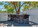 Outdoor deck area under a shade tree featuring bar seating, perfect for entertaining guests at 506 Spring Tree Ct, Tarpon Springs, FL 34689