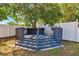 Outdoor deck offering space to sit and relax under the shade of a beautiful, mature tree at 506 Spring Tree Ct, Tarpon Springs, FL 34689