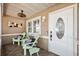 Cozy front porch featuring comfortable seating, stylish decor, and a welcoming entrance with an oval glass door at 506 Spring Tree Ct, Tarpon Springs, FL 34689