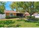 Beautiful single-story house surrounded by a well-manicured lawn, mature trees, and verdant shrubbery at 506 Spring Tree Ct, Tarpon Springs, FL 34689