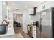 Modern kitchen featuring stainless steel appliances, white countertops, and an open layout with seamless flow to dining area at 506 Spring Tree Ct, Tarpon Springs, FL 34689