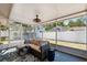 Relaxing screened porch with comfortable seating and view of the backyard at 506 Spring Tree Ct, Tarpon Springs, FL 34689
