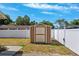 Exterior image of a shed, surrounded by a white fence, in a well maintained backyard at 506 Spring Tree Ct, Tarpon Springs, FL 34689
