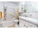 Cozy white bathroom with a bathtub and shower, plus ample storage and a bright mirror at 5915 18Th N St # 11, St Petersburg, FL 33714