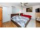 Comfortable bedroom features a ceiling fan, wood floors, and natural light from the window at 5915 18Th N St # 11, St Petersburg, FL 33714