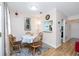 Cozy dining area with wood table set for four, alongside an open view into the kitchen at 5915 18Th N St # 11, St Petersburg, FL 33714