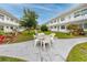 Inviting courtyard view with a patio table set and lush landscaping at 5915 18Th N St # 11, St Petersburg, FL 33714