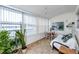Sun-drenched sunroom with large windows, tile flooring, and comfortable seating at 5915 18Th N St # 11, St Petersburg, FL 33714