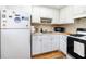 Functional kitchen with white appliances, ample cabinet storage, and essential cooking amenities at 5915 18Th N St # 11, St Petersburg, FL 33714