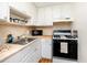 Efficient kitchen space with white cabinets, modern appliances, and functional design at 5915 18Th N St # 11, St Petersburg, FL 33714