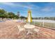 Poolside seating area with tables, chairs, and umbrellas, perfect for relaxing by the water at 5915 18Th N St # 11, St Petersburg, FL 33714