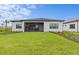 A manicured backyard features a covered, screened lanai and meticulous landscaping at 5958 Talon Preserve Dr, Nokomis, FL 34275