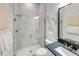 Modern bathroom with glass enclosed shower and a vanity with a dark countertop at 5958 Talon Preserve Dr, Nokomis, FL 34275