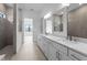 Bright bathroom featuring dual sink vanities, walk in shower, and natural light at 5958 Talon Preserve Dr, Nokomis, FL 34275